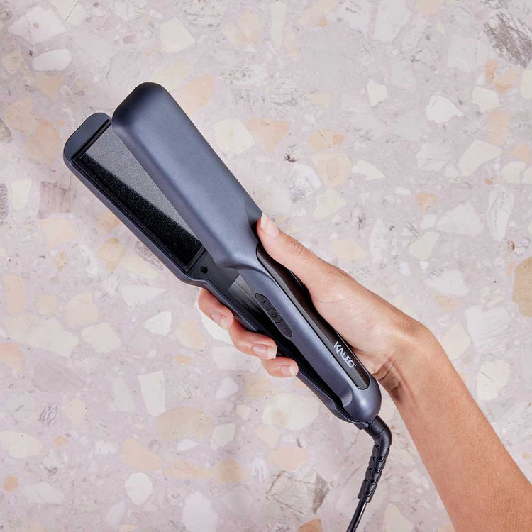 Elevate your styling game with the Kaleo Professional Wide Iron. Perfect for long or thick hair, its wide plates deliver smooth, damage-free styling. Travel-friendly with a safety lock and heat-resistant silicone cap. Ideal for all hair types. Discover the styling tools in Australia exclusively at The DO Salon.