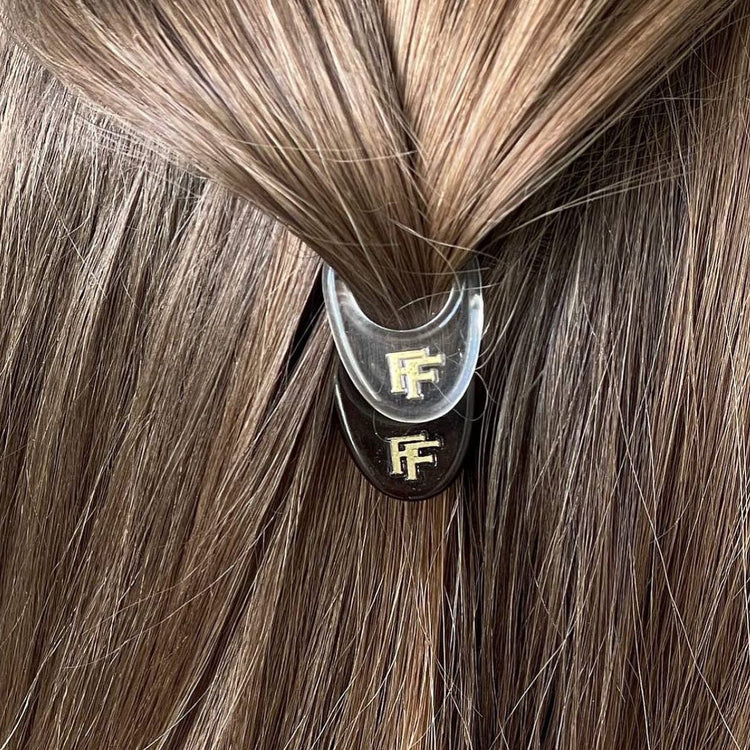Elevate your style with Fiona Franchimon's No.1 HAIRPIN exclusive New York Collection. This limited edition set includes Transparent, Brown, and Black Nº1 Hairpins. Unique curved shape, strong lock, & ultimate flexibility, revolutionary hairpins are five times stronger than regular bobby pins. Shop now at The DO Salon. Lifestyle