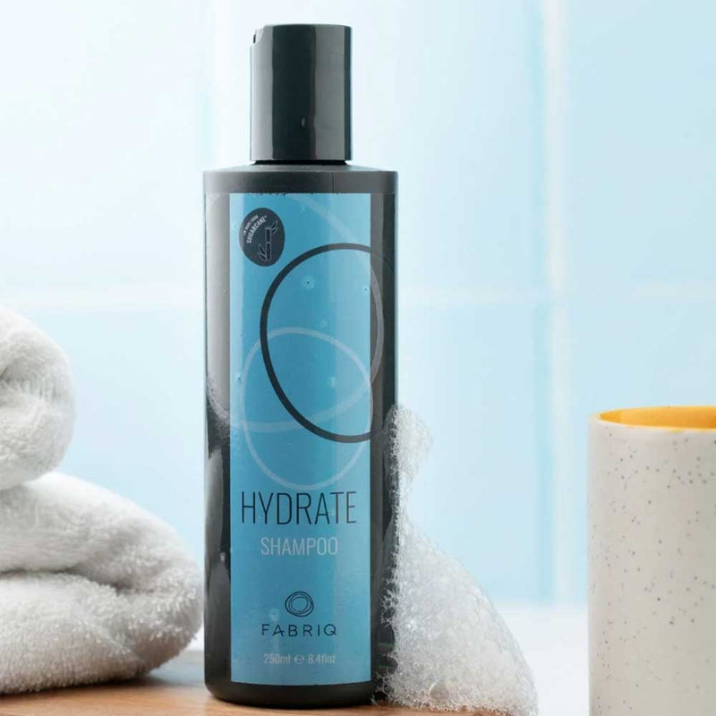 Fabriq Hydrate Shampoo 250ml: Gentle cleanse for dry, frizz-prone hair. Infused with natural oils and botanicals to hydrate, strengthen, and smooth. Available at The DO Salon, St Kilda.