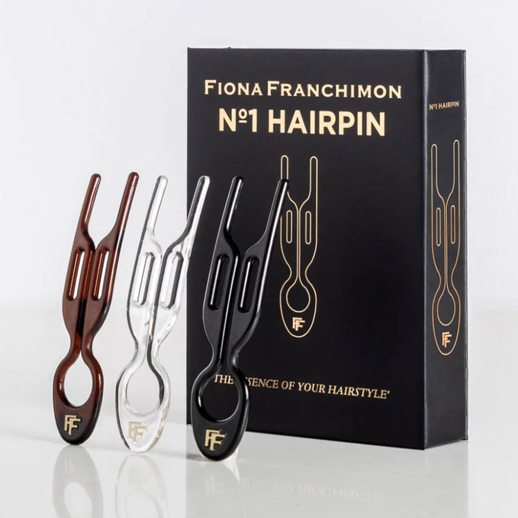 Elevate your style with Fiona Franchimon's No.1 HAIRPIN exclusive New York Collection. This limited edition set includes Transparent, Brown, and Black Nº1 Hairpins. Unique curved shape, strong lock, & ultimate flexibility, revolutionary hairpins are five times stronger than regular bobby pins. Shop now at The DO Salon. Box